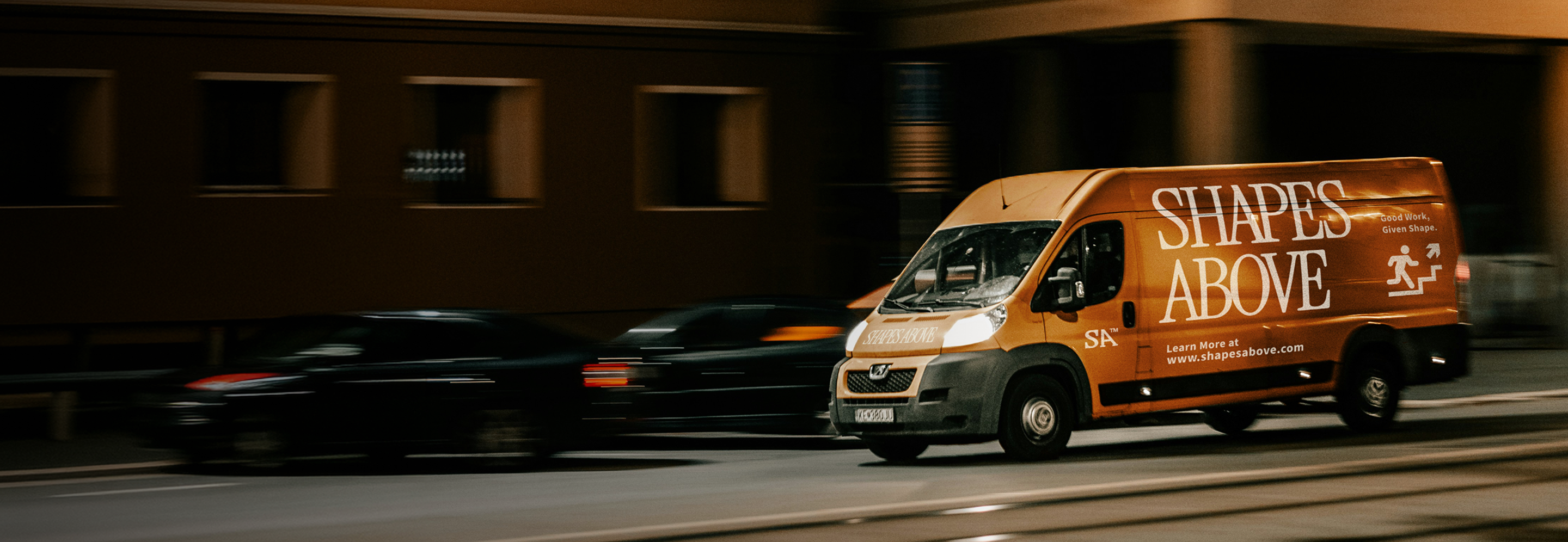 Shapes Above branded orange van in motion